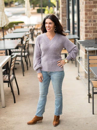 a lilic fuzzy velvet sweater with long sleeves and a v neckline perfect for luxurious cold weather fashion shown with denim