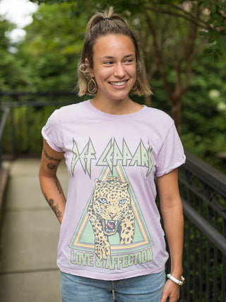 a lavender graphic t shirt with short sleeves featuring the def leppard love and affection logo