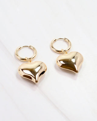 a pair of gold puffed heart shape drop earrings