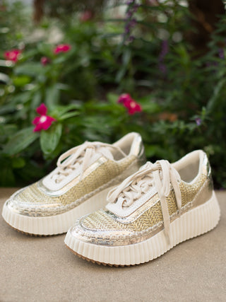a pair of gold sneakers with knit details and metallic accents which make your shoes the statement piece