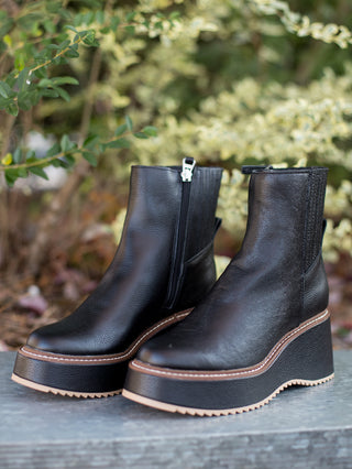 wear these black ankle leather boots with a platform heel to winter and holiday activities in rain sleet or snow