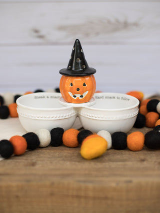 a white double dish for dip that reads sneak a snack and hard snack to follow great for halloween shown with a pumpkin sitter