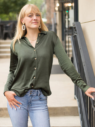 a forest green silk button down blouse with long sleeves perfect for day to night dressing in any season
