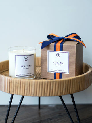 a hand poured amber musk and sage candle and gift box with auburn alabama printed on both