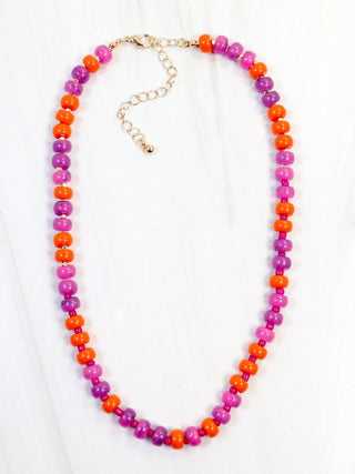 pink and orange beaded necklace with gold accents