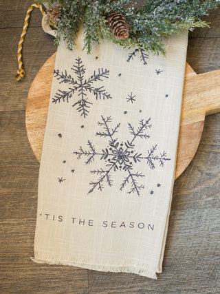 use this navy blue and white tea towel with snowflakes that reads tis the season as christmas decor or give as a holiday gift