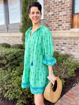 green three quarter sleeve embroidered dress with blue detail and tassel tie closure