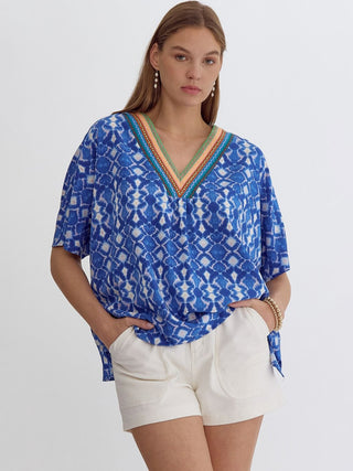 vibrant breezy blue printed v neck top with dolman sleeve and colorful stitch neckline