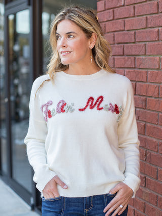 wear this off white christmas sweater with feeling merry across the chest in glitter with pajamas on cozy winter days
