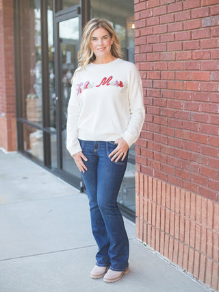 wear this off white christmas sweater with feeling merry across the chest in glitter with jeans on cozy winter days