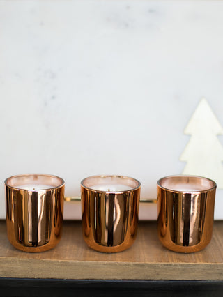 place this trio of metallic bronze votive candles with holiday scents in your home as christmas decor or give as a gift