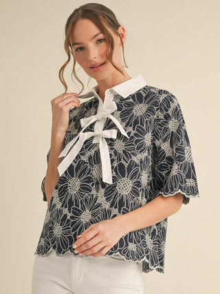 navy eyelet embroidered top with white floral print bow tie front with collar