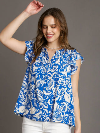 vibrant tropical blue floral print top with short ruffle sleeves and flowy box cut design