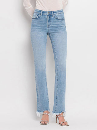 a pair of light wash denim jeans with a bootcut and distressed hem
