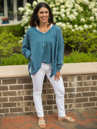 an oversize teal waffle knit top with long sleeves and a v neck perfect for your loungewear collection shown with white pants