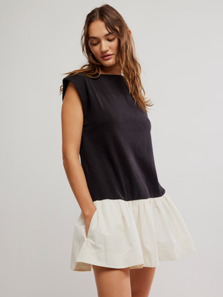 a sleek and sporty black and white mini dress with pockets