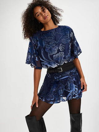 a soft velvet navy mini dress with a drop waist silhouette and flowy bottom