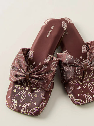 a fabric brown thong sandal with a bandana horse print and a bow like vamp