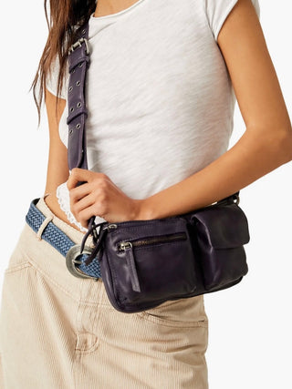 wear this dark purple leather purse with a buckle strap and multiple pockets for everyday functionality and accessorizing 