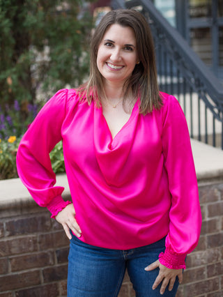 a long sleeve satin blouse in hot pink with draped details perfect for summer to fall fashion