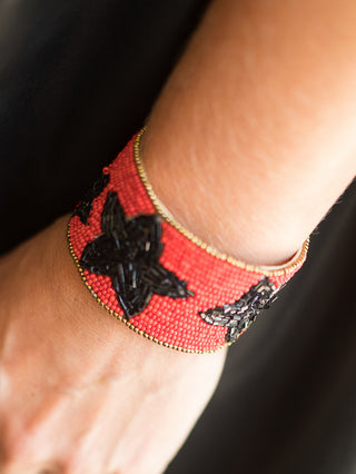 a red and black cuff bracelet with star designs perfect for uga dawgs fans and football game day fashion