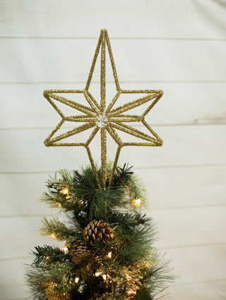 a gold glass christmas tree topper in the shape of a north star perfect for holiday home decor and hostess gifts