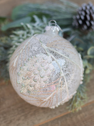 put this white frosted ornament with pinecone patterns on your christmas tree as holiday decor or gift as a stocking stuffer
