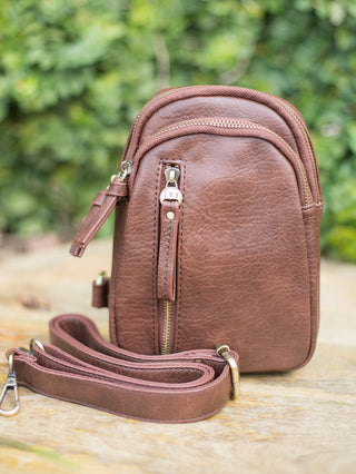 a penny brown purse in faux leather with versatile sling straps and zipper compartments great for on the go 