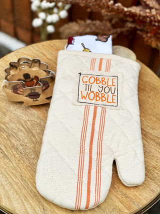 a seasonal kitchen set with a gobble oven mitt and dish towel with wooden spoon and turkey cookie cutter