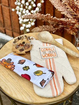 a seasonal kitchen set with a gobble oven mitt and dish towel with wooden spoon and turkey cookie cutter