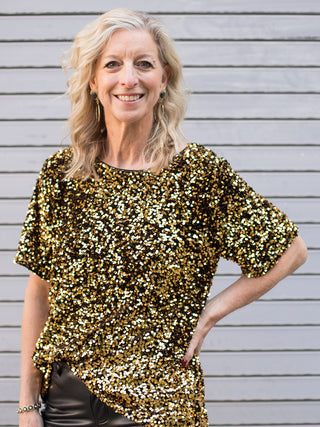 wear this gold sequin short sleeve top in a relaxed fit to holiday and christmas gatherings for a sparkly winter outfit