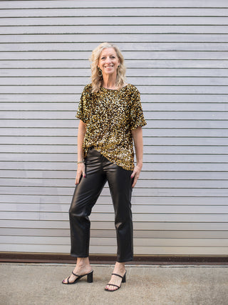 wear this gold sequin short sleeve top in a relaxed fit with faux leather pants to holiday and christmas gatherings 