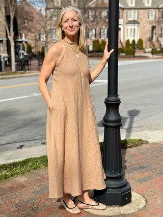 a long and flowy warm natural colored mock neck maxi dress