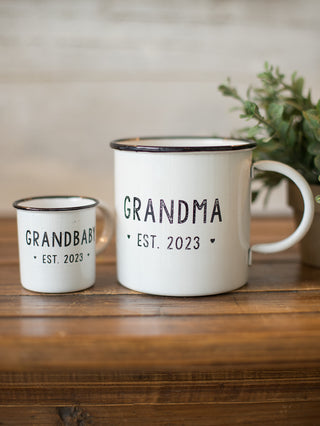 this two piece grandma and grandbaby est 2023 mug set includes an enamel coated metal coffee mug and matching mini mug