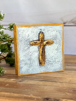 a square gold hand painted block with a textured religious cross