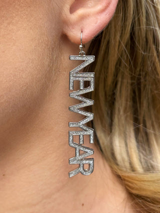 dazzling long silver earring that says new year