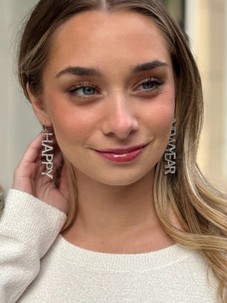 dazzling silver happy new year dangling earrings