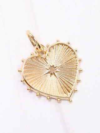gold heart charm with spike edges 