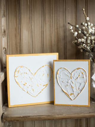 a birchwood art piece with a gold heart against white background