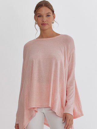 a soft pink flowy long sleeve top with a boat neckline