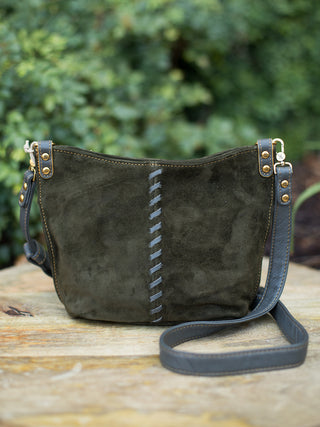 a dark green purse with crossbody straps and braided detailing down the front perfect for everyday fall accessorizing
