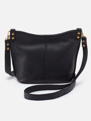 a black leather crossbody purse with a magnetic closure and gold accents
