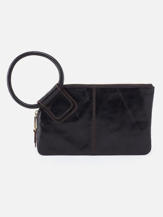 a leather clutch in black with a vintage circular handle