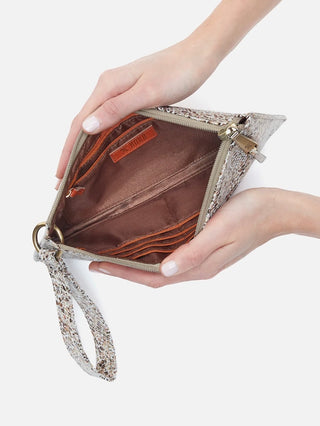 a terrazzo print leather clutch with a wrist strap and zipper closure featuring organizational pouches inside