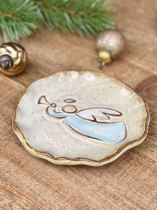 a stoneware holiday trinket dish with an angel image