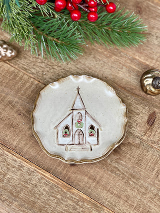 a stoneware holiday trinket dish with a holy church image
