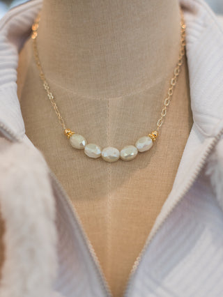 wear this classy gold chain necklace with pearlescent crystals that hit below the collarbone for sophisticated events