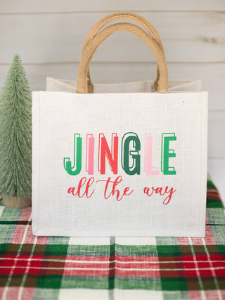 a white christmas present bag that reads jingle all the way perfect for holiday home decor and host gifts