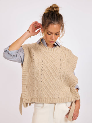 a ribbed knit sleeveless oatmeal colored sweater vest with side ties