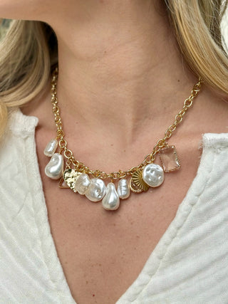 charm necklace of gold rolo link chain with pearls gold charms and crystals
